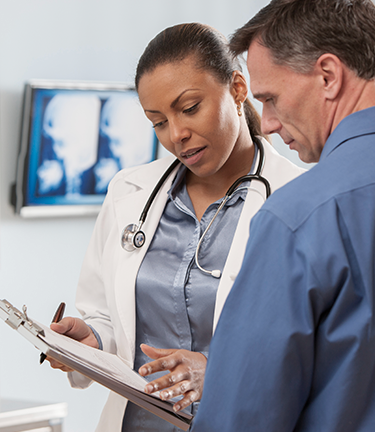 Medical Insurance Doctor discusses with patient the options available from his medical insurance coverage