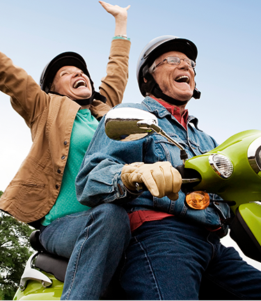 Retirement Pension Vested employee enjoying his retirement with his wife while riding a Vespa