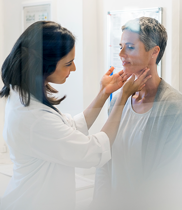 Voluntary Health Benefits Doctor checking patients neck glands for signs of illness